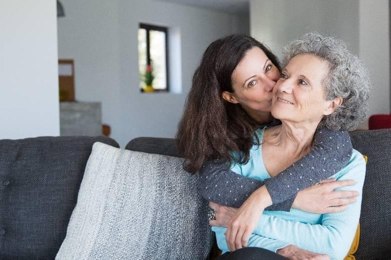 Image: Female adult child hugging older mother
